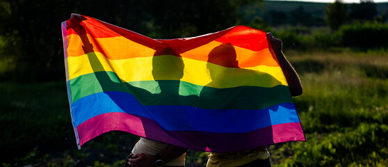 couple holding rainbow flag for pride month