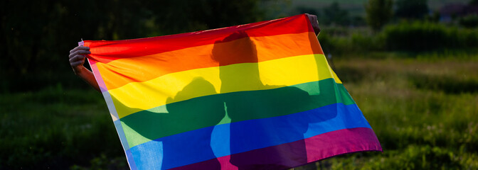 couple holding rainbow flag for pride month