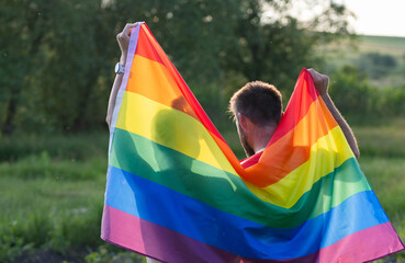 couple holding rainbow flag for pride month