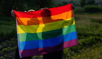couple holding rainbow flag for pride month
