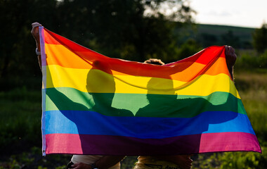 couple holding rainbow flag for pride month