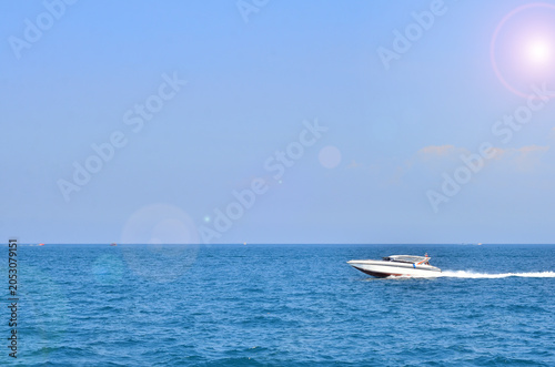 The speedboat sailing in the deep blue sea combined with the beautiful view of the sky.
