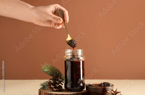 Female hand with jar and bo...