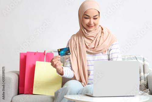 Muslim woman with credit ca...