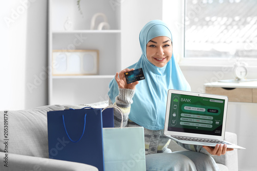 Muslim woman with credit ca...