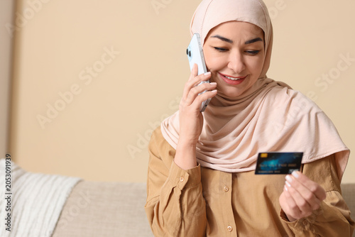 Muslim woman with credit ca...