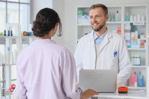Smiling male pharmacist ass...
