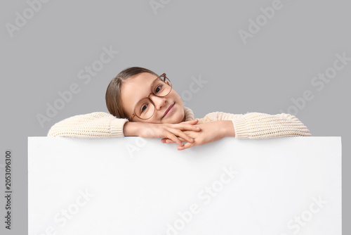 Cute girl with blank poster...