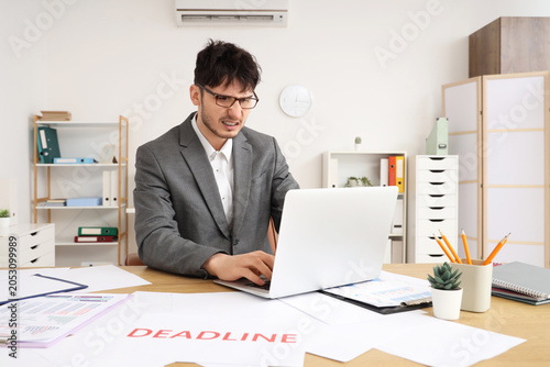 Stressed businessman workin...
