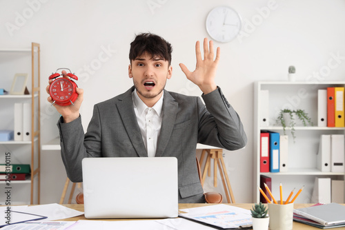 Stressed businessman holdin...