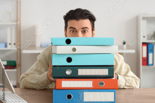Overwhelmed businessman hid...
