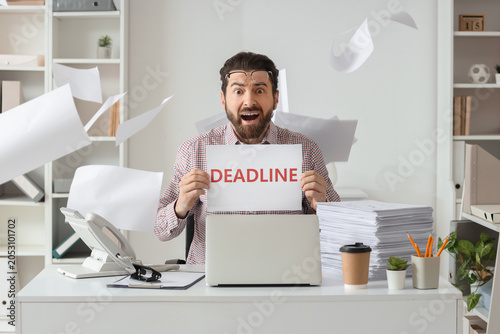 Stressed businessman holdin...