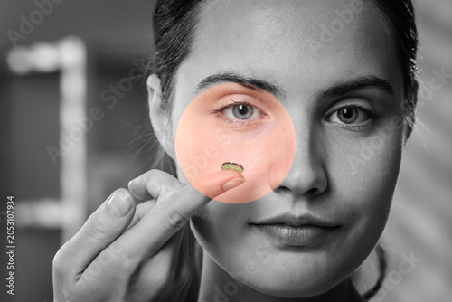 Photos Young woman with green contact lens, closeup
