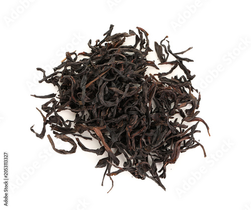 Obraz na plátně Heap of dry black tea leaves isolated on white background, closeup