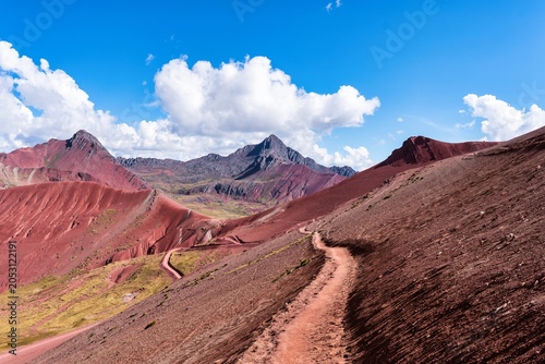 Quadro em tela Hiking on the Red Mountain Trail With Clouds and Blue Sky in a Remote Landscape