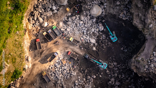 Fotografie Excavator and Garbage Truck Mine Work in Stone and Sand Mining, Construction and