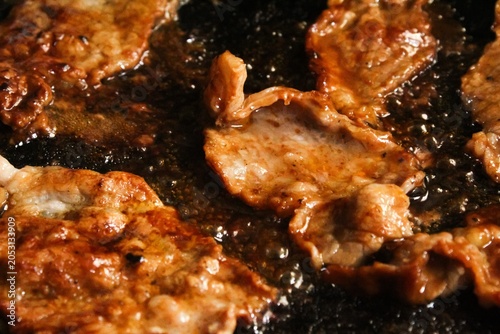 flat lay of marbled beef slices roasted in a pan