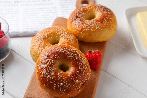 Board with tasty bagels and...