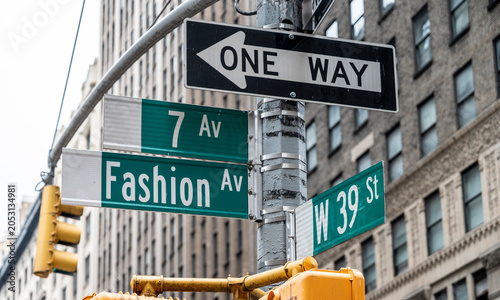 Fashion or 7th Avenue and West 39th St. street signs in New York City.
