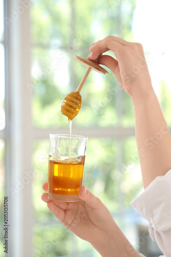 Young woman with jar of tas...