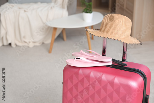 Packed suitcase with hat an...