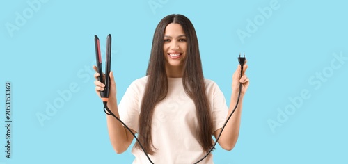 Smiling woman holding hair ...