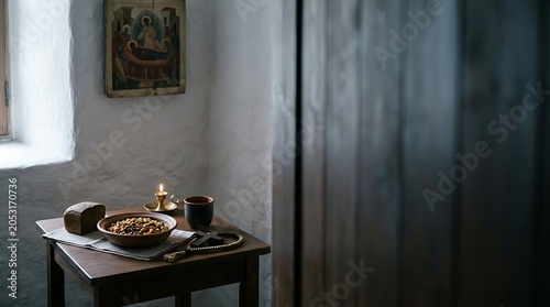 Simple monastic meal with bread and candle beside a religious icon