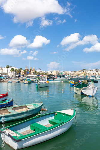 Marsaxlokk village harbor of Malta, Mediterranean traditional colorful boats luzzu.