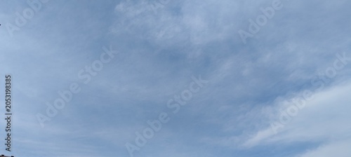Muted Pale Blue Sky with Subtle Wispy Cloud Layers Nature Background