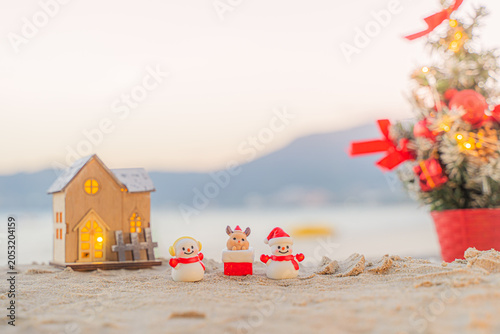 Santa Claus Doll Cute and Christmas Tree House Relaxing on the Beach. Merry Christmas Holiday. Bright Background. Patong Beach, Phuket, Thailand.