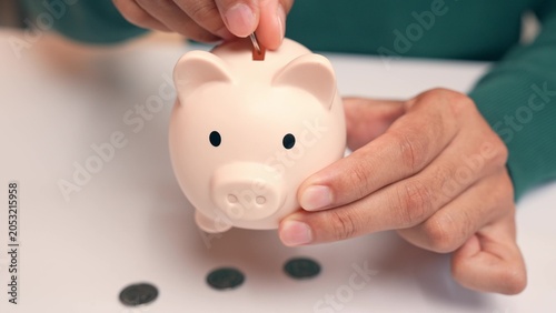 Canvastavla An office worker puts coins into a piggy bank, but they fall straight out the bottom, symbolizing failed saving efforts, financial setbacks, instability, and the frustration of unmet financial goals