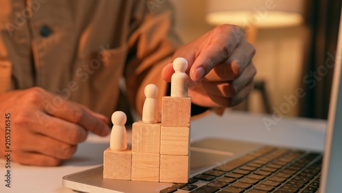 Bild auf Leinwand A strategist places a male wooden figure at the top while female figures remain lower, symbolizing workplace inequality, the gender gap in career advancement, challenges in organizational diversity