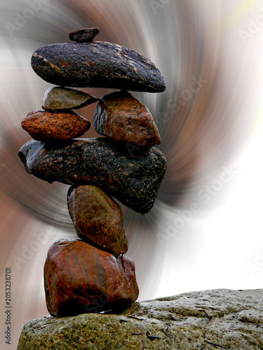Stacked stones balancing on a rock creating an inukshuk composition for stability