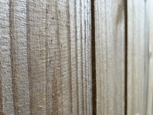 Natural Wood Plank Texture Background with Shallow Depth of Field. Natural unpainted wood plank texture background with soft lighting. Natural wood fence with selective focus.