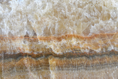 polished natural stone with crystalline layered and onyx pattern in warm beige gold tone