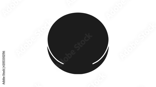 Black ice hockey puck isolated on dark background.