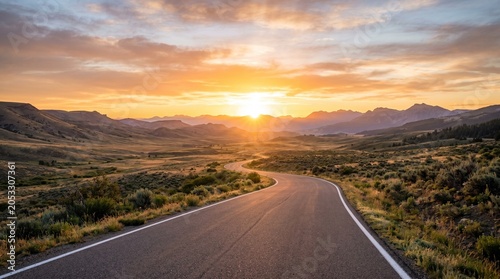An empty winding asphalt road leading towards majestic mountain peaks in the background, illuminated by a dramatic golden sunrise with light rays and a touch of morning mist.