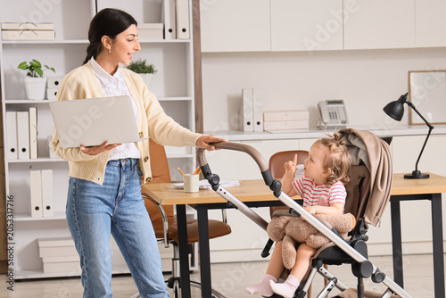Working mother with laptop ...