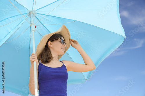 Young woman in straw hat an...