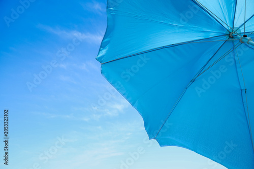 Bright blue beach umbrella ...