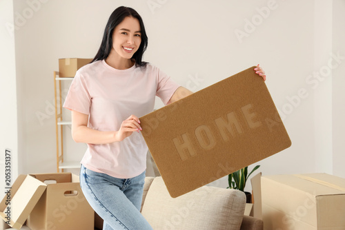 Smiling young woman holding...