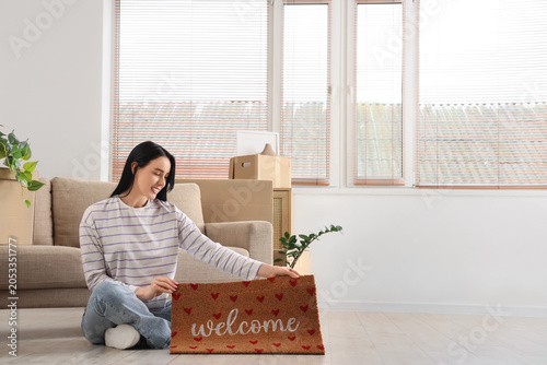 Happy young woman moving in...