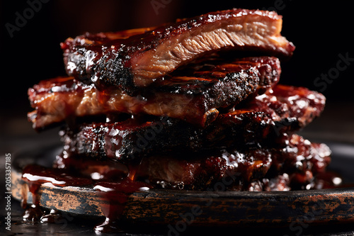 Slow cooked brown sugar glazed pork ribs stack on a rustic platter