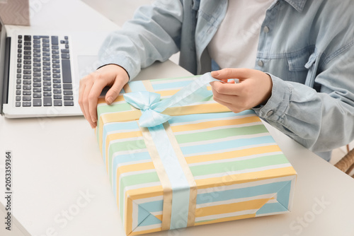 Person opening striped gift...