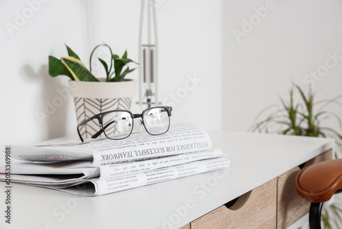 Reading glasses on stack of...