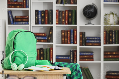 Green backpack with headpho...
