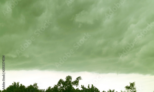 Surreal Pop Art of Dramatic Sky with Tempest over Foliage in Deep Green Color