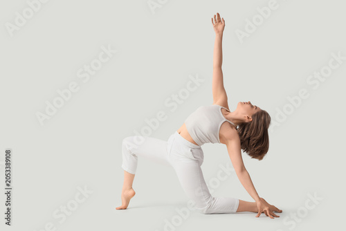 Young woman practicing yoga...