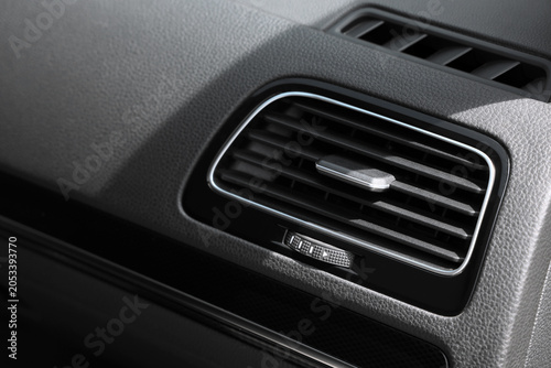 Konstfotografi Modern car dashboard air vent with chrome trim and adjustable louvers for climat