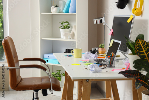 Photography Messy home office desk with laptop, monitor, and crumpled paper, creative worksp